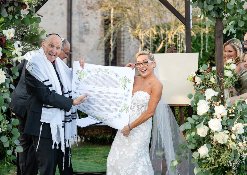Bill and Lyndsay holding their ketubah.